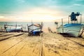 Old fishing boats laid over the sea shore. Colorful sunset above the sandy beach in Ravda, Bulgaria.