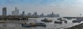 Old fishing boats near fish market in panama city with skyline background