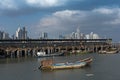 Old fishing boats near fish market in panama city with skyline background