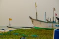 old fishing boats in the sand on the ocean in India on blue sky background Royalty Free Stock Photo