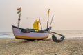 old fishing boats in the sand on the ocean in India on blue sky background Royalty Free Stock Photo