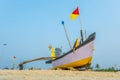 old fishing boats in the sand on the ocean in India on blue sky background Royalty Free Stock Photo