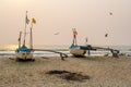 old fishing boats in the sand on the ocean in India on blue sky background Royalty Free Stock Photo