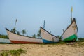 old fishing boats in the sand on the ocean in India on blue sky background Royalty Free Stock Photo