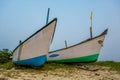 old fishing boats in the sand on the ocean in India on blue sky background Royalty Free Stock Photo