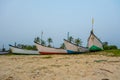 old fishing boats in the sand on the ocean in India on blue sky background Royalty Free Stock Photo