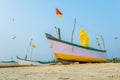 old fishing boats in the sand on the ocean in India on blue sky background Royalty Free Stock Photo