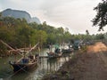 Old fishing boats stand in a row near the beach on a background of mountains Royalty Free Stock Photo