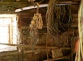 Old fishing gear and rigging hang out to dry in a dark makeshift stone shed. Fishing nets, mooring ropes, a winch, on a wooden Royalty Free Stock Photo