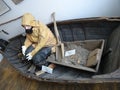 An old fishing man sitting in a boat in museum Royalty Free Stock Photo