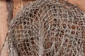 Old fishing nets hanging on wooden wall Royalty Free Stock Photo