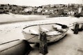 Old fishing rowing boat abandoned in the harbour in Cornwall Royalty Free Stock Photo