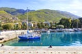 View of the pier of the bay, where old fishing schooners, boats and boats are moored in the clear waters of the Ionian Sea