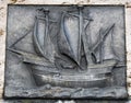 Old, flat sculpture of a ship,