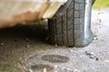 Old flat tire on the car, dirty rusty Royalty Free Stock Photo