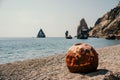 Old rusty round floating marine mines on the beach with rocky shore and sea background. Pollution, nature protection