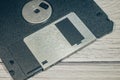 Old floppy disk close-up. There is a part of the floppy disk in the frame. The focus is set on the aluminum gate valve.