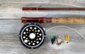 Old fly reel and rod on rustic wood Royalty Free Stock Photo