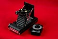 Old Folding Camera and Exposure Meter on a Red Background Royalty Free Stock Photo