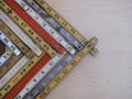 Old folding rulers, metric and inches, in a chevron suggesting growth, increase
