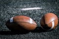 Old Footballs on a football field Royalty Free Stock Photo