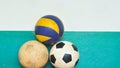 Old footballs and volleyball with cement wall Royalty Free Stock Photo