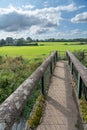 Old footbridge crossing a stream Royalty Free Stock Photo