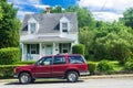 an old ford bronco is parked in front of the house Royalty Free Stock Photo