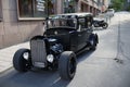 An old ford hot rod standing by its self our in the streets of stockholm