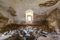 Old forsaken empty basement room of ancient building or palace with cracked plastered brick walls, low arched ceiling, small Royalty Free Stock Photo