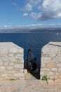 Old fort cannon in Hydra island with ocean in background