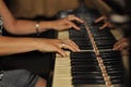 Old fortepiano with female woman hands, close up. Hands of a girl on the piano keys.