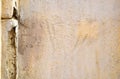 Old foundation and plaster wall with cracks. Building requiring repair closeup Royalty Free Stock Photo