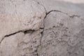 Old foundation and plaster wall with cracks. Building requiring repair closeup. Royalty Free Stock Photo