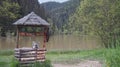 An old fountain with mountain water, at the edge of the water and at the foot of the mountains Royalty Free Stock Photo