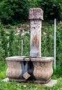 Old fountain near the church of Corgnon Royalty Free Stock Photo