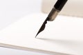 Old fountain pen with clipping path write on white paper background Royalty Free Stock Photo