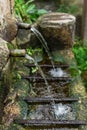 Old fountain poursing water from two spouts Royalty Free Stock Photo