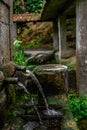 Old fountain poursing water from two spouts Royalty Free Stock Photo