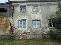 Old four-storey abandoned dilapidated house. Very old residential building.