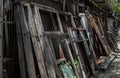 Old frames and shutters with glass from dismantled are stacked against each other front of front warehouse waiting to be sold at Royalty Free Stock Photo