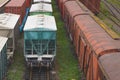 Old freight rail cars are on the track at the railway