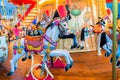 Old French carousel in a holiday park. Merry-go-round with horses Royalty Free Stock Photo