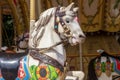 Old French carousel in a holiday park during sunny day. Horses on a traditional fairground vintage carousel. Merry-go-round with Royalty Free Stock Photo