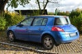 Old metal blue French Renault Megane II with diesel 1.9 engine compact car parked
