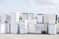 Old fridges freezers refrigerant gas at refuse dump skip recycle stacked pile plant help environment reduce pollution white silver Royalty Free Stock Photo