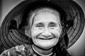 Old friendly woman with vietnamese straw hat