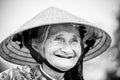 Old friendly woman with vietnamese straw hat