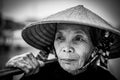 Old friendly woman with vietnamese straw hat