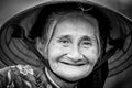 Old friendly woman with vietnamese straw hat